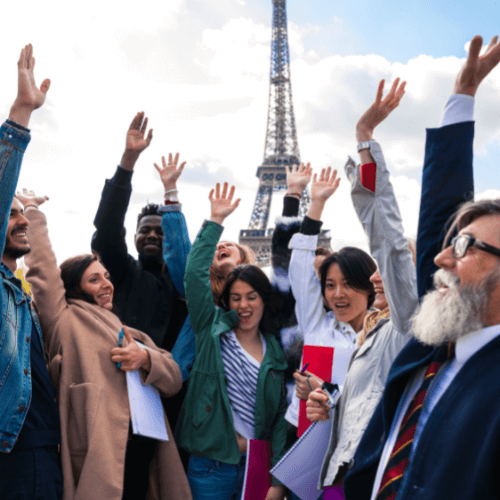 People raising hands by the Eiffel Tower